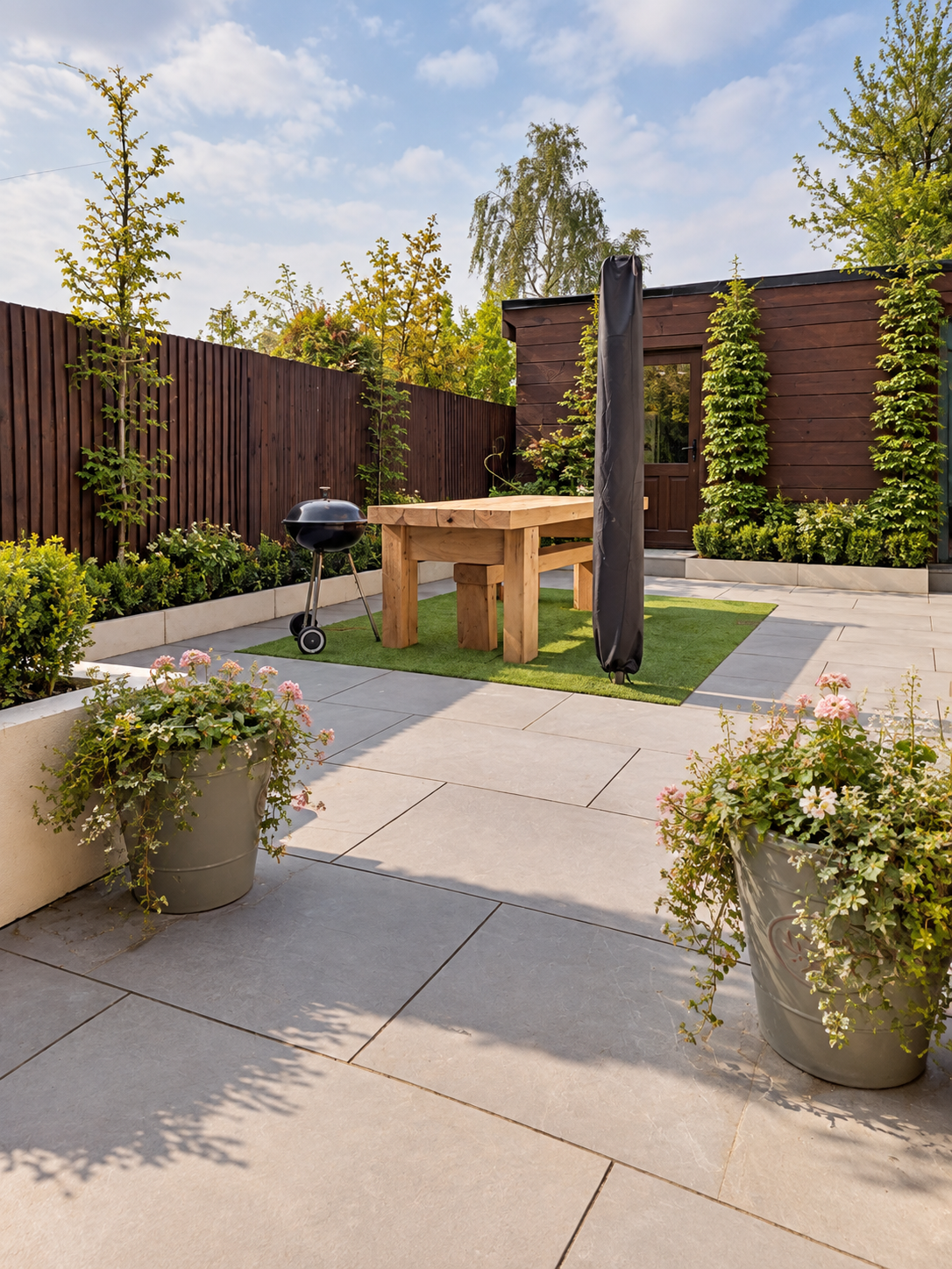 Grey porcelain patio with rendered garden walls in Haslemere