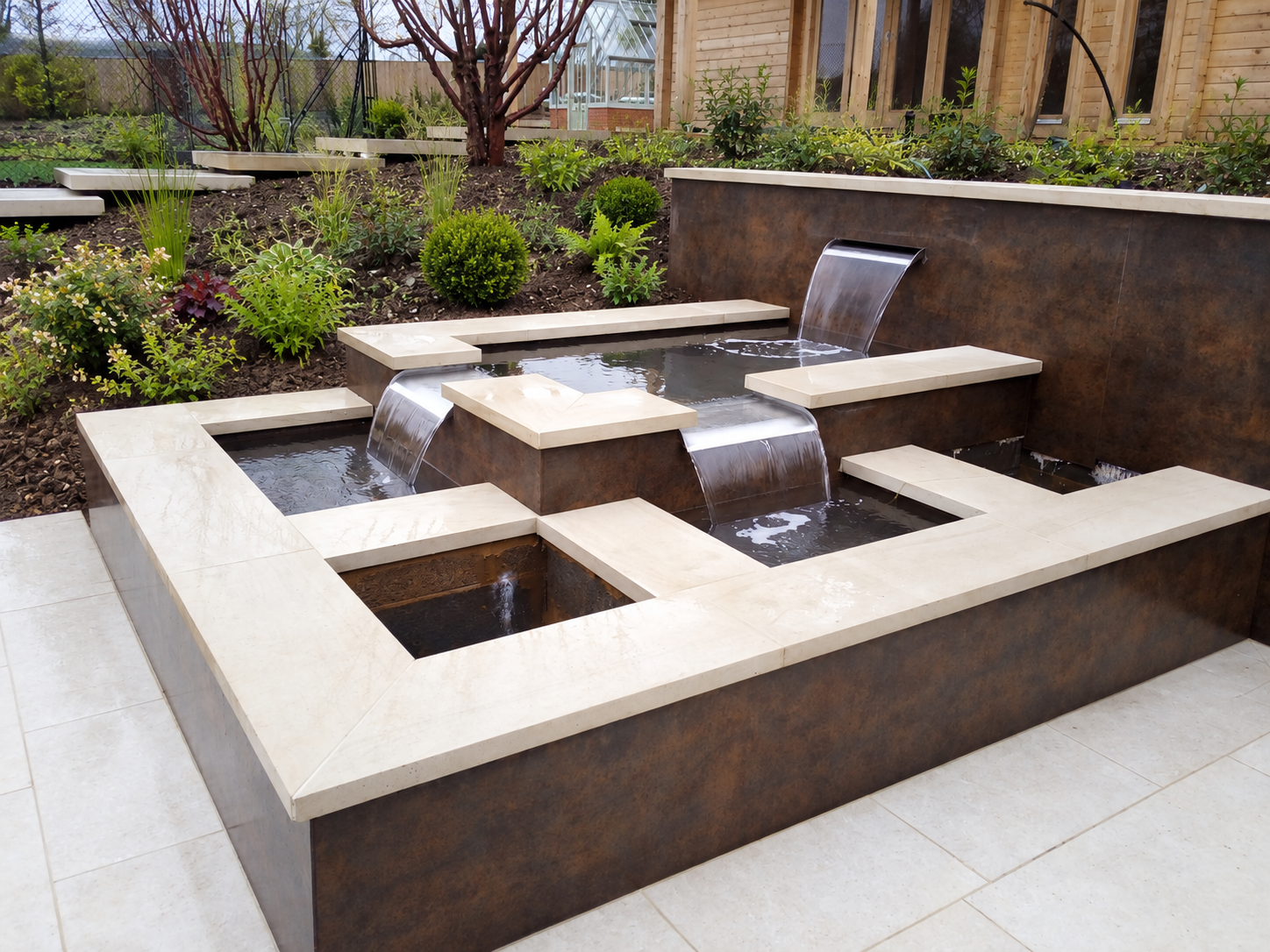 Modern water feature, large-format steps and wall tiles in Farnham