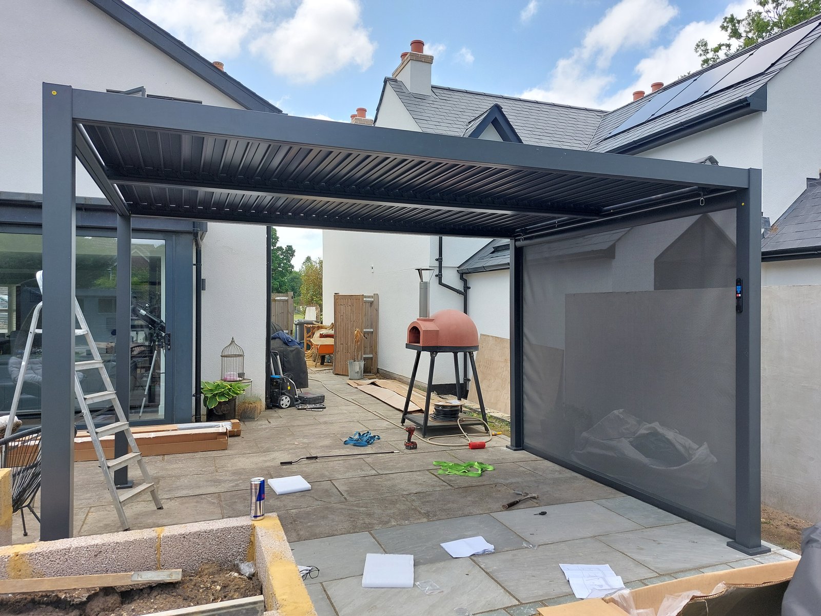 Motorised louvered pergola and landscaped garden in Elstead